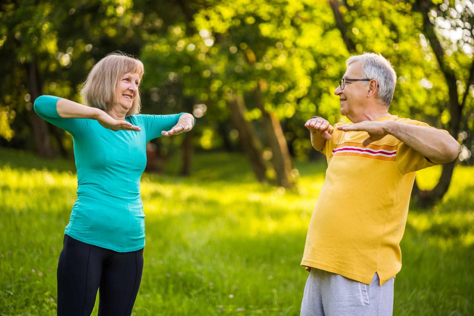 Older couple exercising together outdoors, the kind of regular, unhurried activity that holds mobility in place