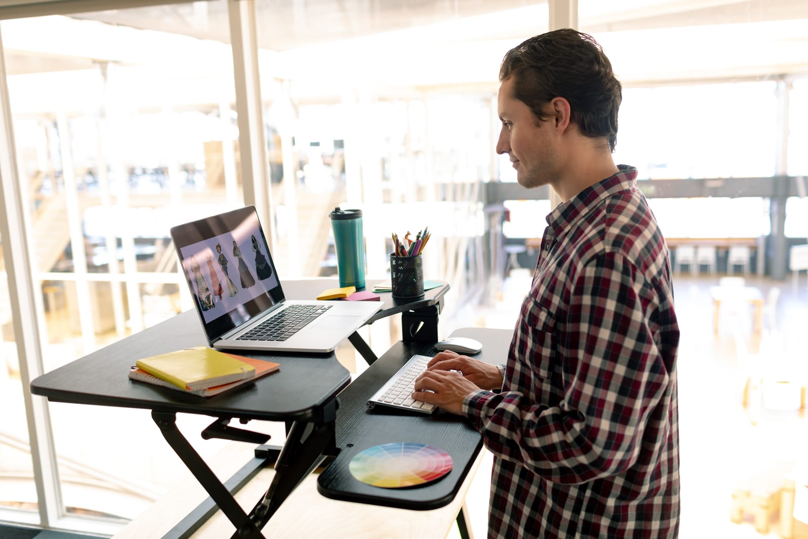 Standing desk set up with the screen at eye level and the keyboard at elbow height, one way to break up a day of sitting