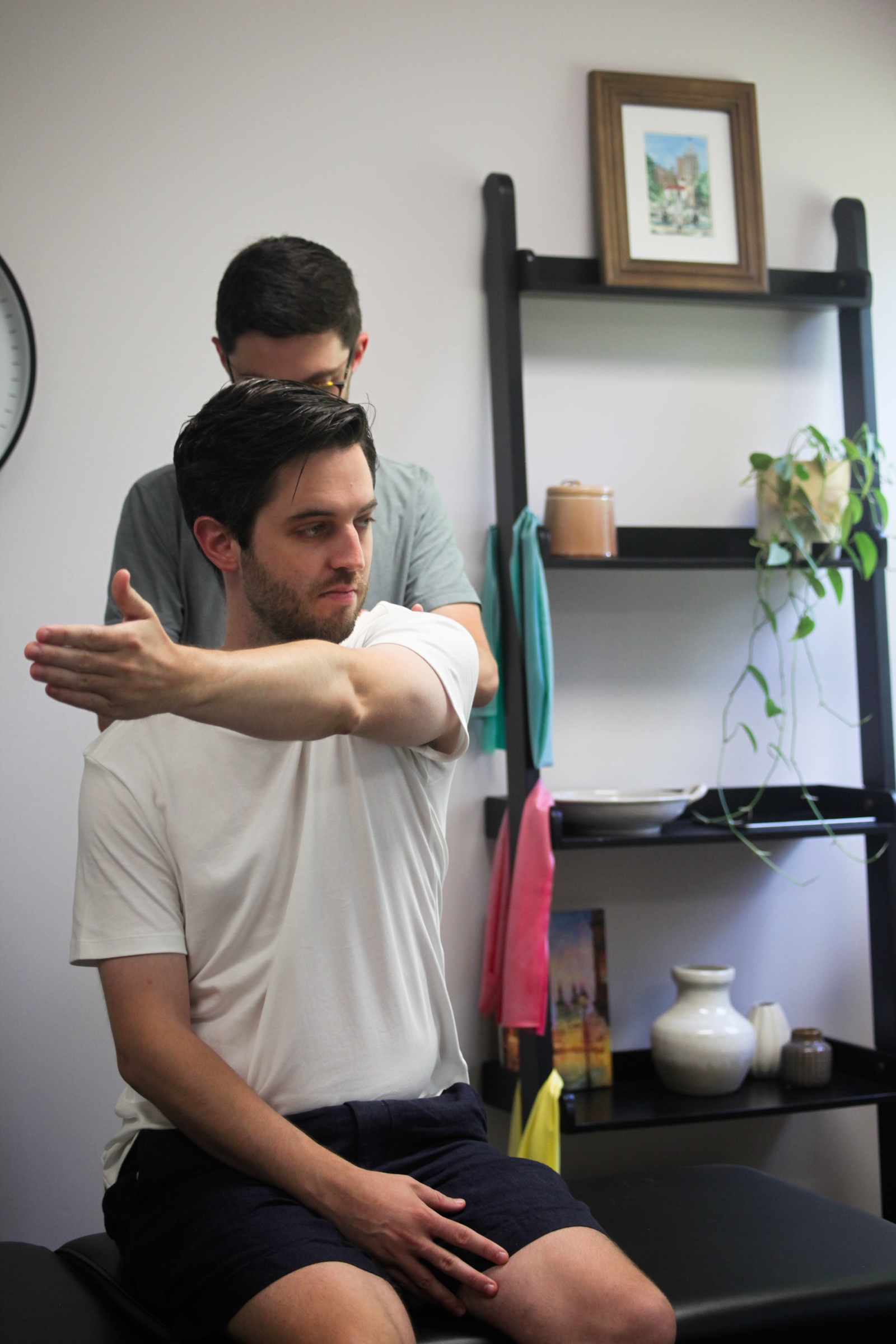 Guided cross-body shoulder stretch, the same move that keeps a golf swing finishing freely