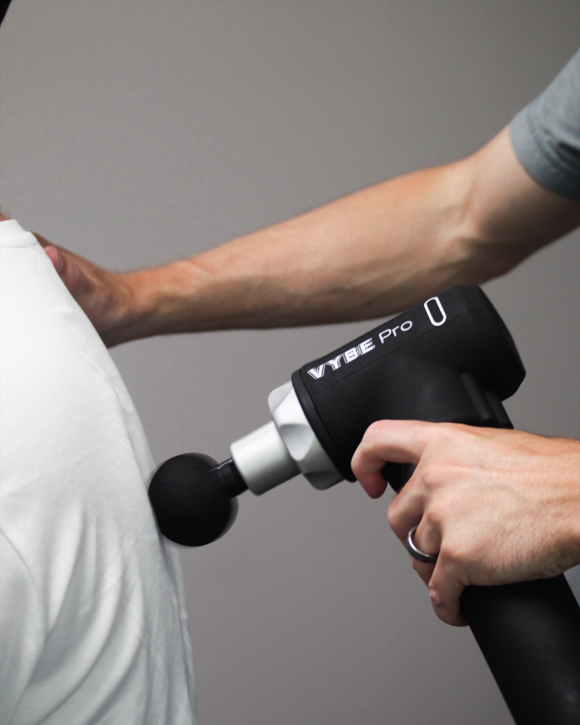 Soft tissue work with a percussion device, which helps settle post-adjustment tenderness